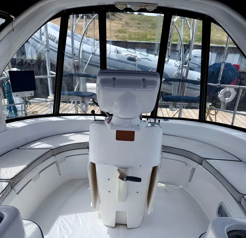 Slide: The Image of Interior view of a 1998 Hunter 410 sailboat cockpit with seating and helm. - 9