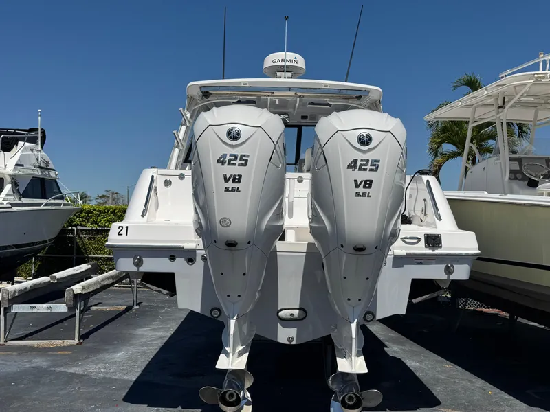 Slide: The Image of 2019 Everglades 340 Dual Console boat with twin 425 V8 engines, docked outdoors. - 12