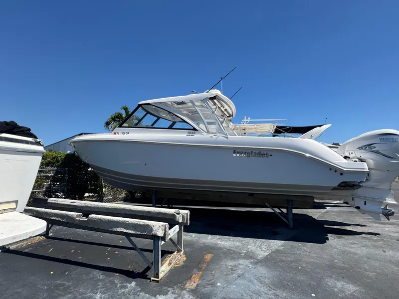 Slide: The Image of 2019 Everglades 340 Dual Console boat on a trailer under clear blue sky. - 15