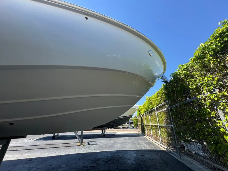 Slide: The Image of 2019 Everglades 340 Dual Console boat on display under clear blue sky. - 17