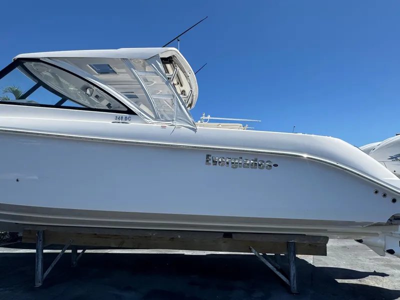 Slide: The Image of 2019 Everglades 340 Dual Console boat on display under clear blue sky. - 19