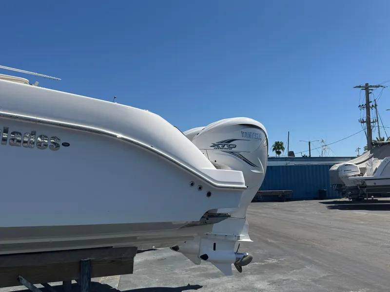 Slide: The Image of 2019 Everglades 340 Dual Console boat with Yamaha engine, parked outdoors under clear sky. - 20