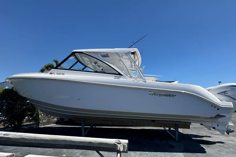 Slide: The Image of 2019 Everglades 340 Dual Console boat on display under clear blue sky. - 23