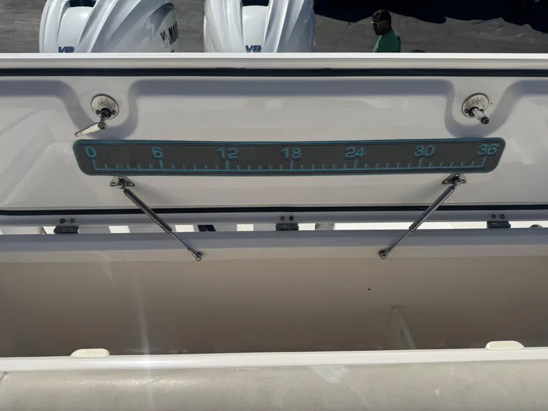 Slide: The Image of Open storage compartment on 2019 Everglades 340 Dual Console boat with measuring scale. - 25