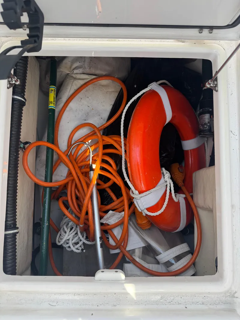 Slide: The Image of Storage compartment with life ring and ropes on 2019 Everglades 340 Dual Console boat. - 30