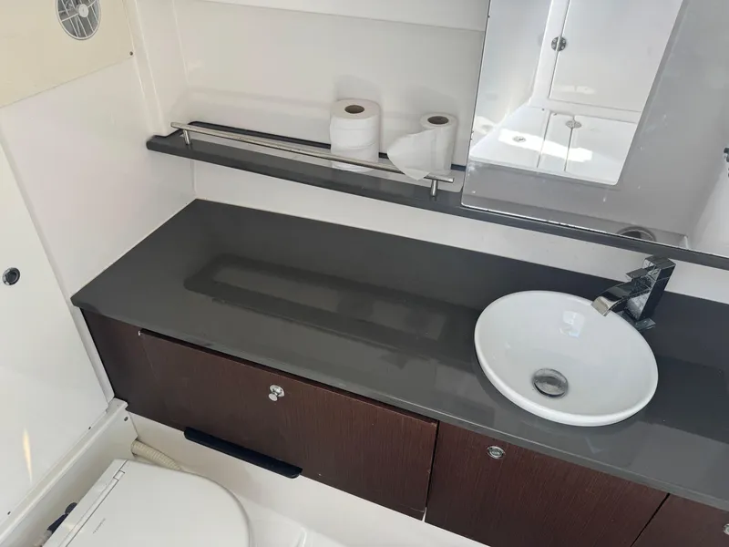 Slide: The Image of Bathroom interior of 2019 Everglades 340 Dual Console boat with sink and storage. - 31