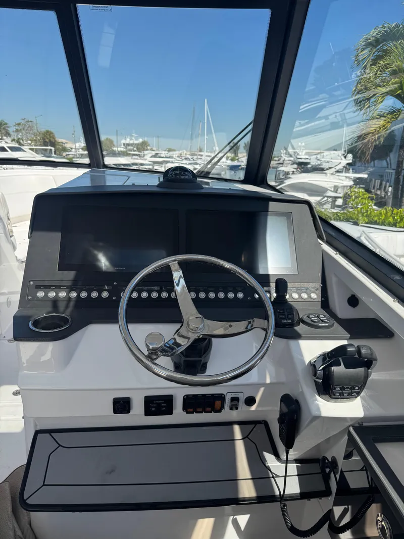 Slide: The Image of 2019 Everglades 340 Dual Console boat helm with modern controls and navigation screens. - 35