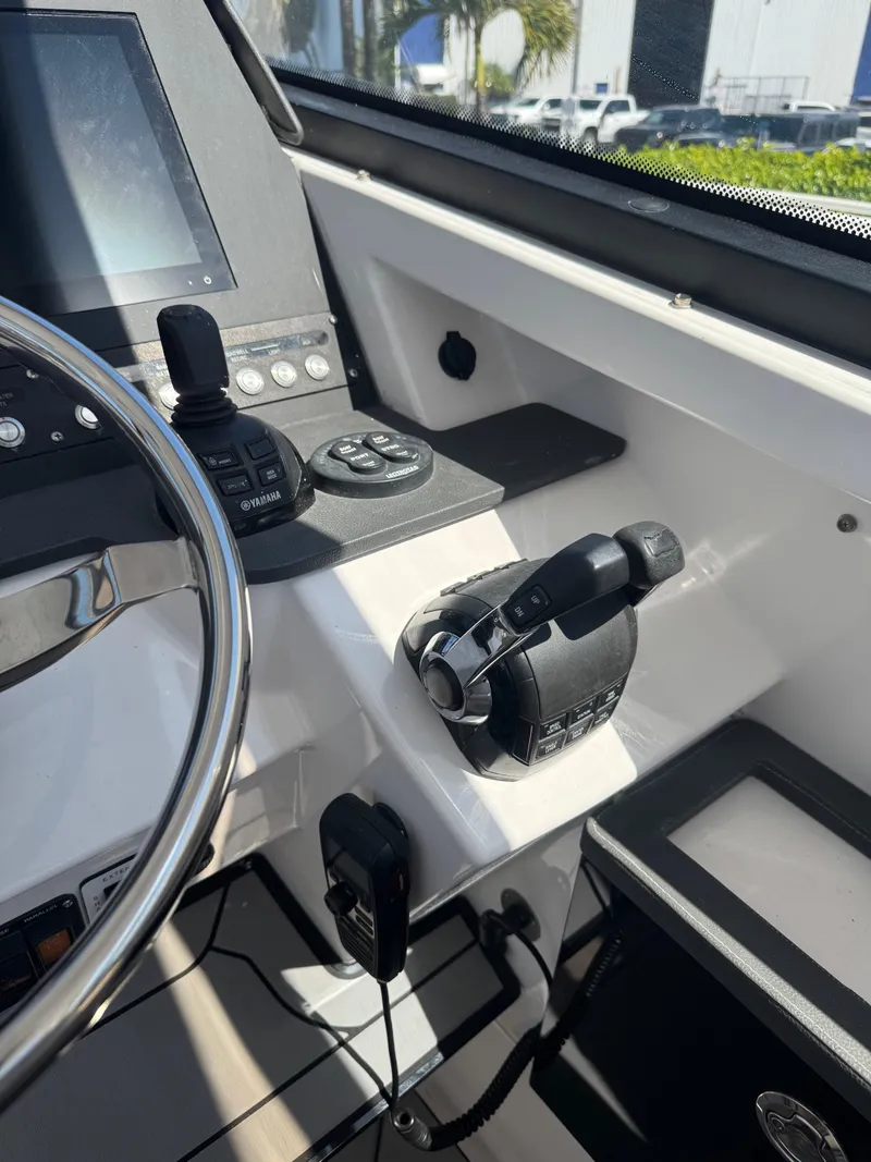 Slide: The Image of Control panel of 2019 Everglades 340 Dual Console boat, featuring steering wheel and throttle. - 36