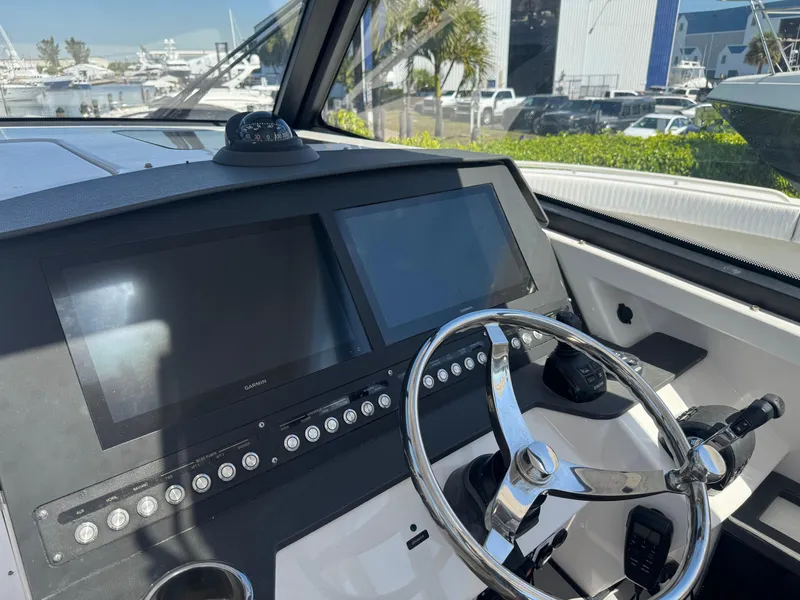 Slide: The Image of Cockpit view of 2019 Everglades 340 Dual Console boat with modern navigation screens. - 40