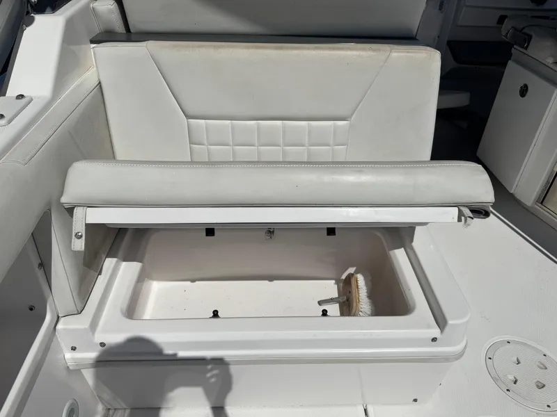 Slide: The Image of 2019 Everglades 340 Dual Console boat seat with storage compartment open. - 41