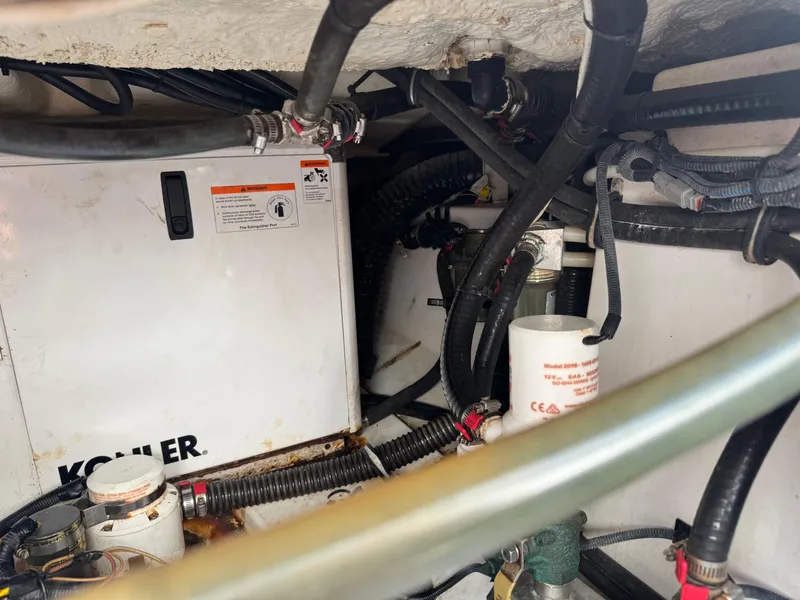 Slide: The Image of Engine compartment of 2019 Everglades 340 Dual Console with Kohler generator and wiring. - 44