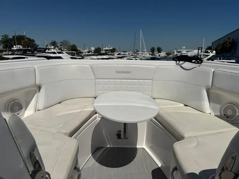 Slide: The Image of 2019 Everglades 340 Dual Console boat interior with white seating and table. - 47