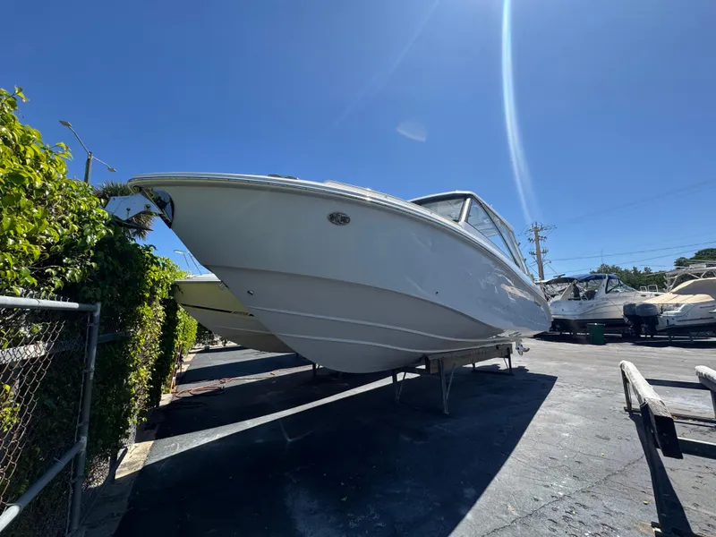 Slide: The Image of 2019 Everglades 340 Dual Console boat on display under clear blue sky. - 6