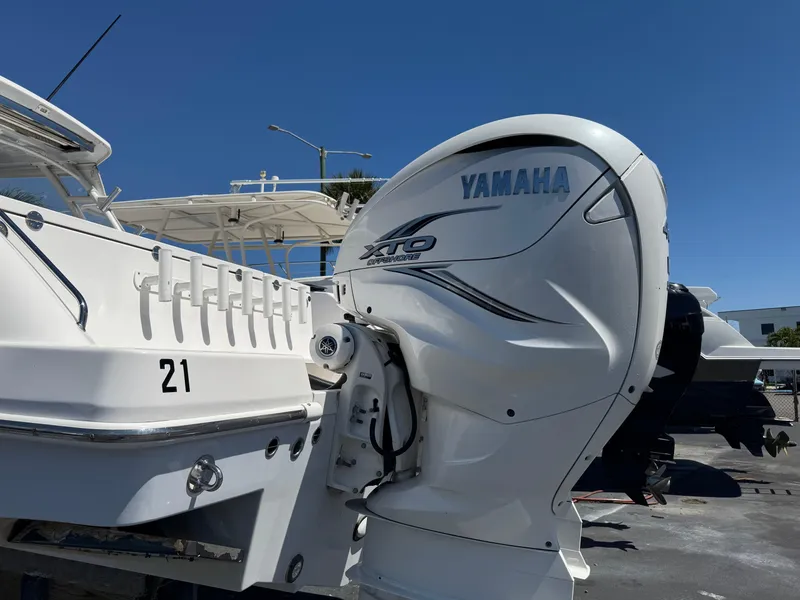 Slide: The Image of 2019 Everglades 340 Dual Console with Yamaha XTO outboard engine, docked under clear blue sky. - 8