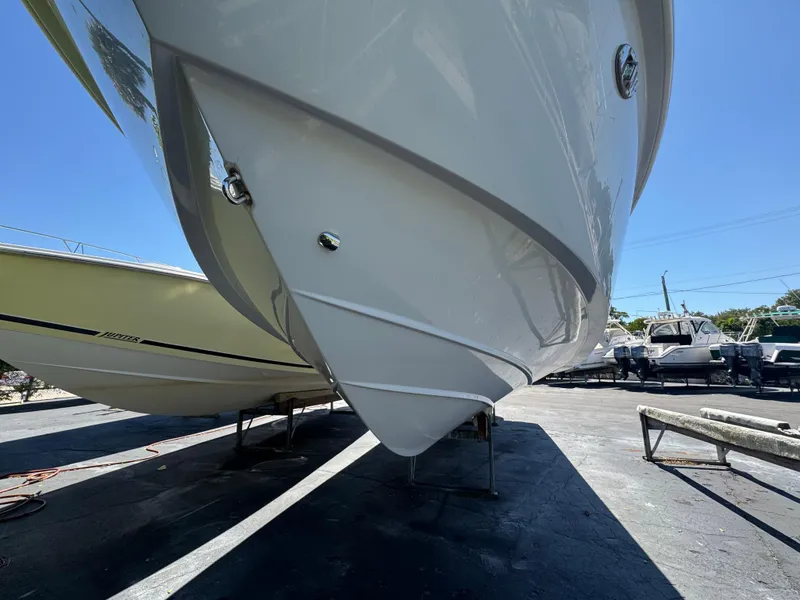 Slide: The Image of 2019 Everglades 340 Dual Console boat hull in a marina setting. - 9