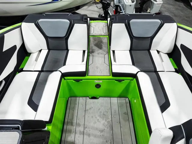 Slide: The Image of 2022 Yamaha Boats 255XD interior with modern seating and vibrant green accents. - 11