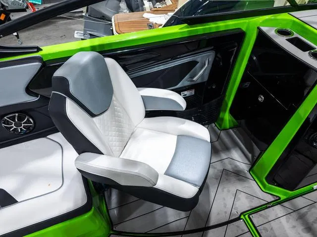 Slide: The Image of 2022 Yamaha Boats 255XD interior with modern seating and vibrant green accents. - 15