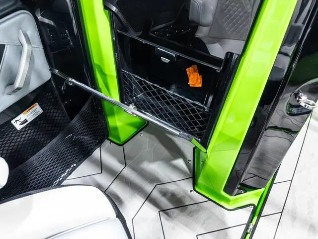 Slide: The Image of Interior view of 2022 Yamaha Boats 255XD, featuring green accents and storage compartments. - 16