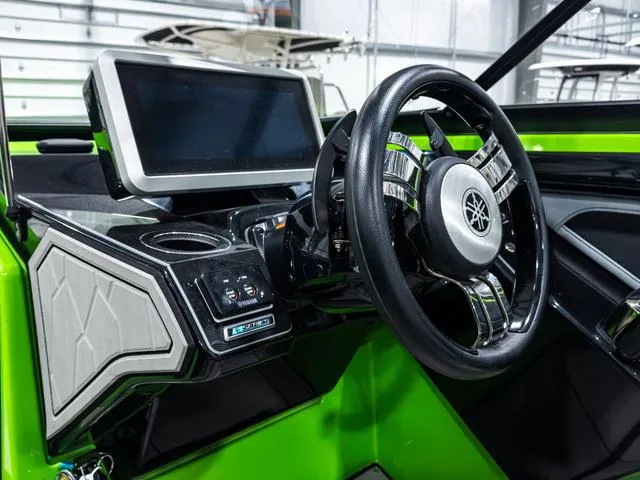 Slide: The Image of 2022 Yamaha Boats 255XD dashboard with steering wheel and touchscreen display. - 18