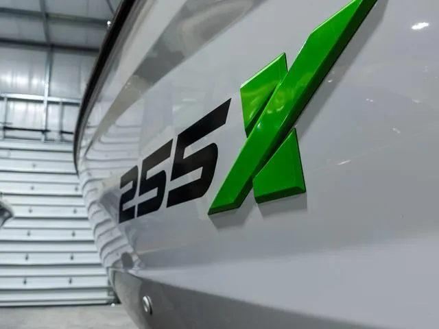 Slide: The Image of 2022 Yamaha Boats 255XD model with green "255X" logo in a showroom. - 2