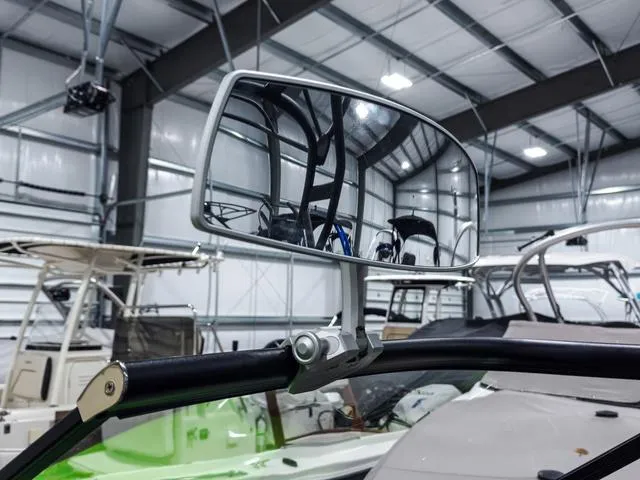 Slide: The Image of 2022 Yamaha Boats 255XD rearview mirror in a boat showroom. - 20