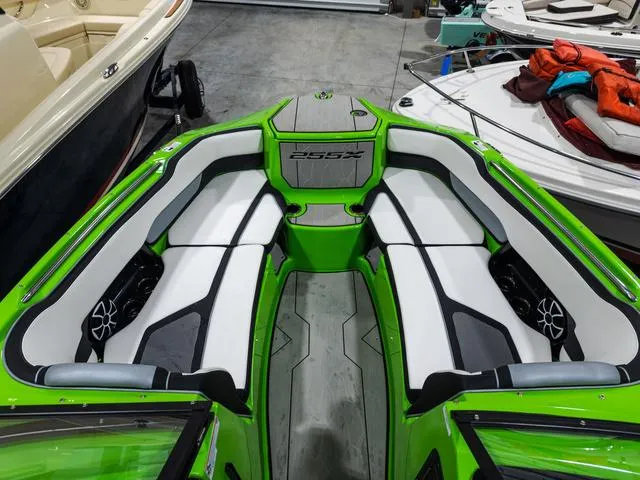 Slide: The Image of 2022 Yamaha Boats 255XD with green and white interior, docked in a garage. - 21