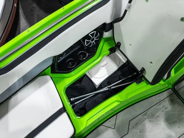 Slide: The Image of Interior view of a 2022 Yamaha Boats 255XD, featuring green accents and storage compartments. - 23