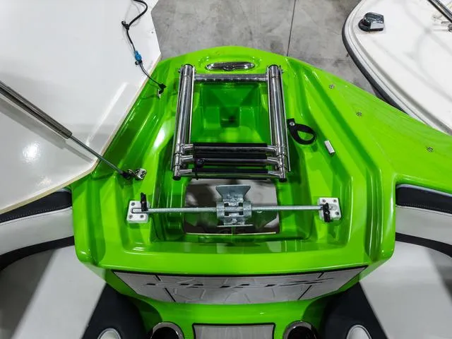 Slide: The Image of 2022 Yamaha Boats 255XD, vibrant green deck with stainless steel ladder and fittings. - 24