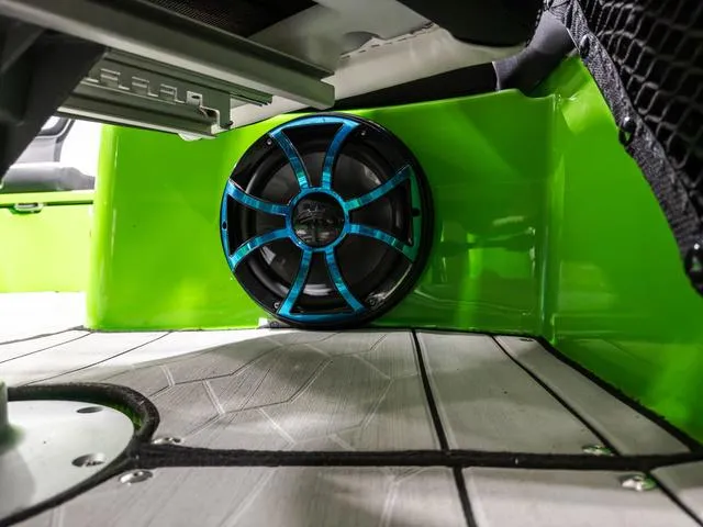 Slide: The Image of 2022 Yamaha Boats 255XD interior with vibrant green panel and stylish speaker. - 27