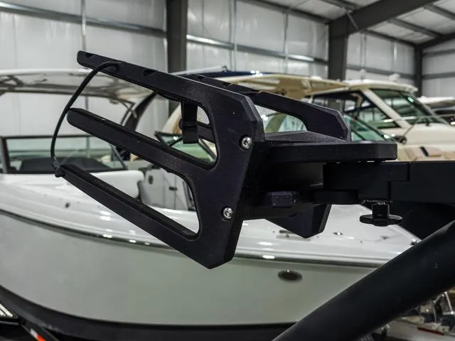 Slide: The Image of 2022 Yamaha Boats 255XD wakeboard rack in a showroom setting. - 28