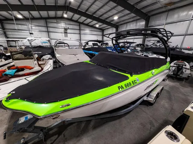 Slide: The Image of 2022 Yamaha Boats 255XD in a showroom, featuring a vibrant green and black design. - 3