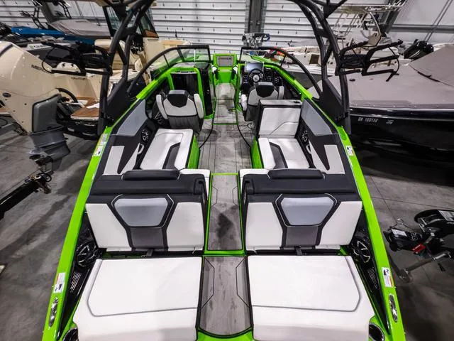 Slide: The Image of 2022 Yamaha Boats 255XD interior with green accents and modern seating design. - 6