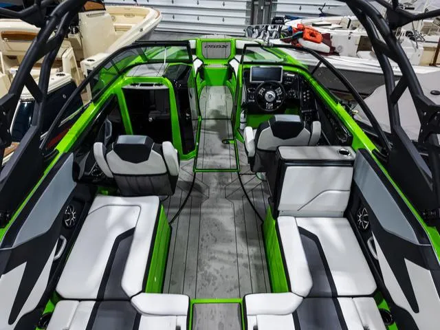 Slide: The Image of 2022 Yamaha Boats 255XD interior with green accents and modern seating arrangement. - 8