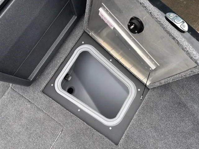Slide: The Image of 2025 Tracker Pro Guide V-175 WT boat storage compartment, open with gray interior. - 10
