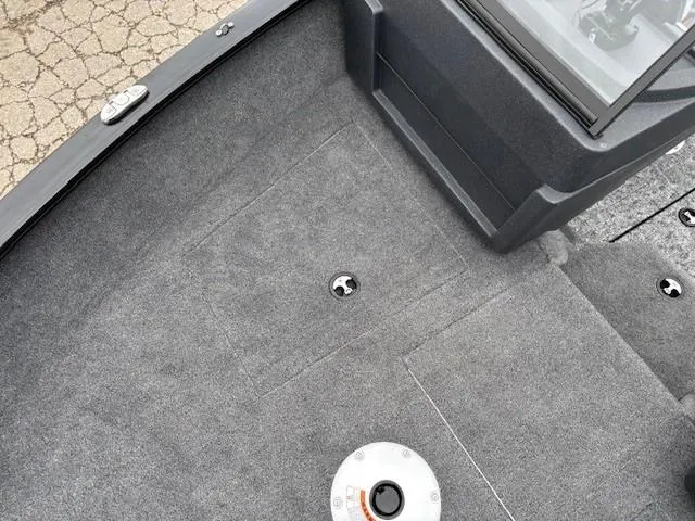 Slide: The Image of 2025 Tracker Pro Guide V-175 WT boat interior with gray carpet flooring. - 11