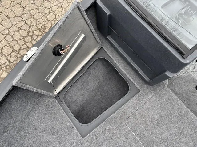 Slide: The Image of 2025 Tracker Pro Guide V-175 WT boat storage compartment with open hatch. - 12