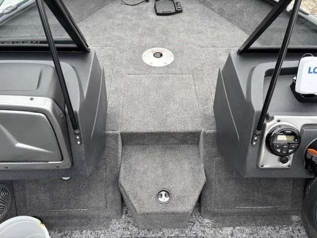 Slide: The Image of 2025 Tracker Pro Guide V-175 WT boat interior, featuring carpeted flooring and control panel. - 13