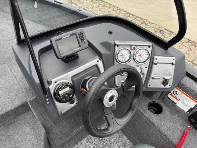 Slide: The Image of 2025 Tracker Pro Guide V-175 WT boat dashboard with steering wheel and gauges. - 16