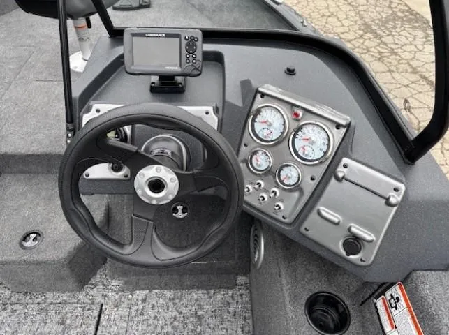 Slide: The Image of 2025 Tracker Pro Guide V-175 WT boat dashboard with steering wheel and gauges. - 17