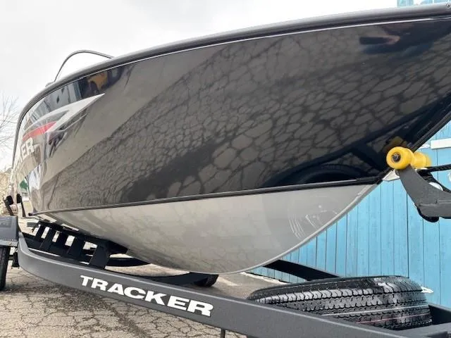 Slide: The Image of 2025 Tracker Pro Guide V-175 WT boat on trailer, sleek black hull design. - 2