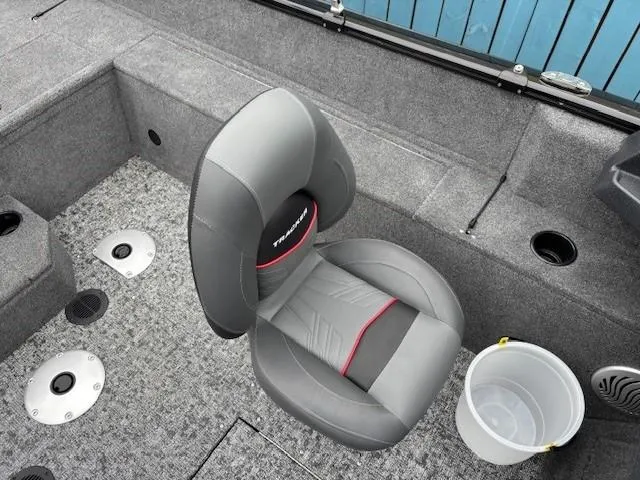 Slide: The Image of 2025 Tracker Pro Guide V-175 WT boat interior with gray seating and carpeted flooring. - 21
