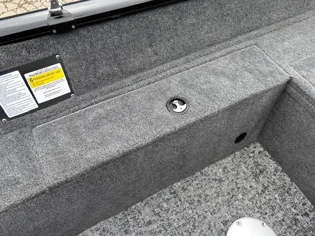 Slide: The Image of 2025 Tracker Pro Guide V-175 WT boat interior with gray carpet and storage compartment. - 24