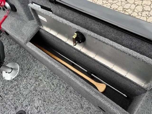 Slide: The Image of Storage compartment in 2025 Tracker Pro Guide V-175 WT boat with paddle and rod. - 25
