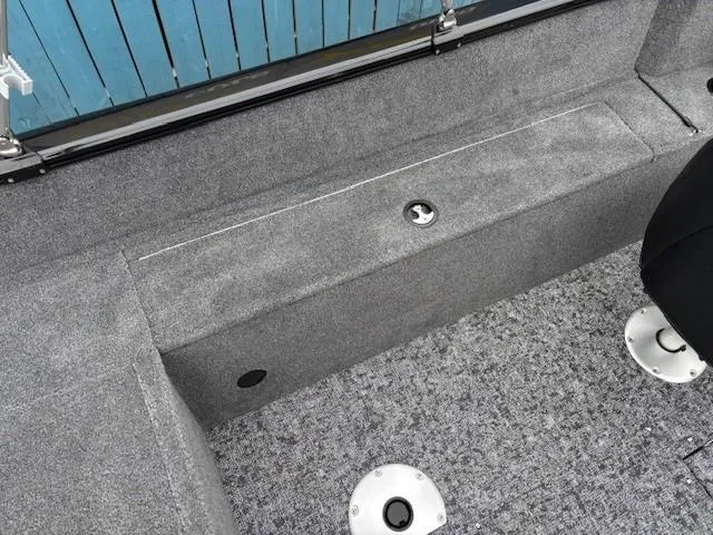 Slide: The Image of Interior of 2025 Tracker Pro Guide V-175 WT boat, featuring gray carpeted flooring and seating. - 26