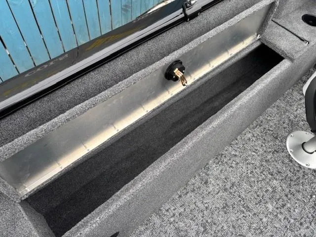 Slide: The Image of 2025 Tracker Pro Guide V-175 WT boat storage compartment with carpeted interior. - 27