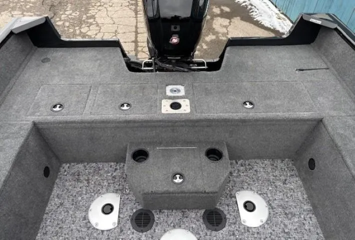 Slide: The Image of 2025 Tracker Pro Guide V-175 WT boat interior with gray carpet and storage compartments. - 28