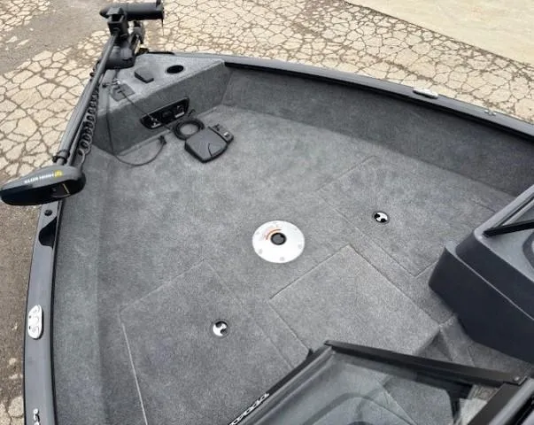 Slide: The Image of 2025 Tracker Pro Guide V-175 WT boat deck with trolling motor and carpeted surface. - 7