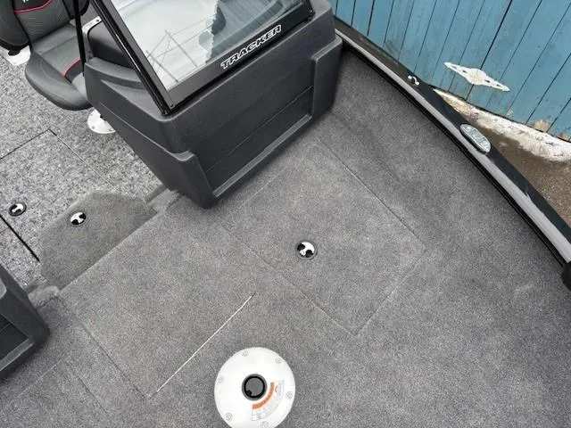 Slide: The Image of 2025 Tracker Pro Guide V-175 WT boat interior with carpeted deck and storage compartments. - 9