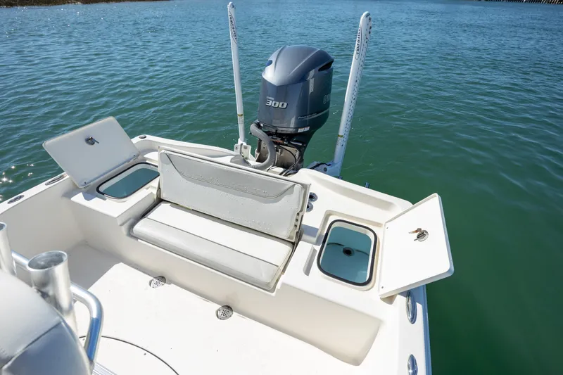 Slide: The Image of 2017 Avenger AV24 boat stern with outboard motor on calm water. - 11