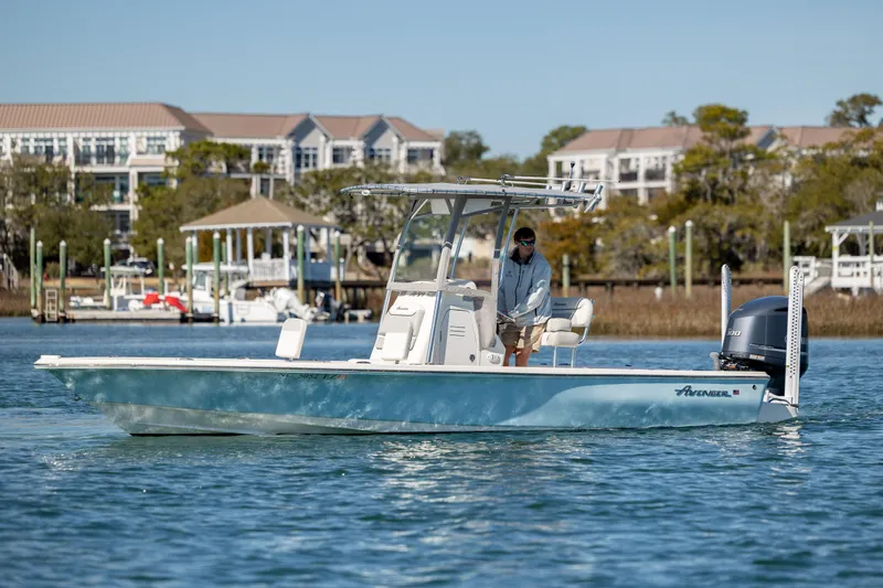Slide: The Image of 2017 Avenger AV24 boat on water near residential area, featuring sleek design and powerful engine. - 5